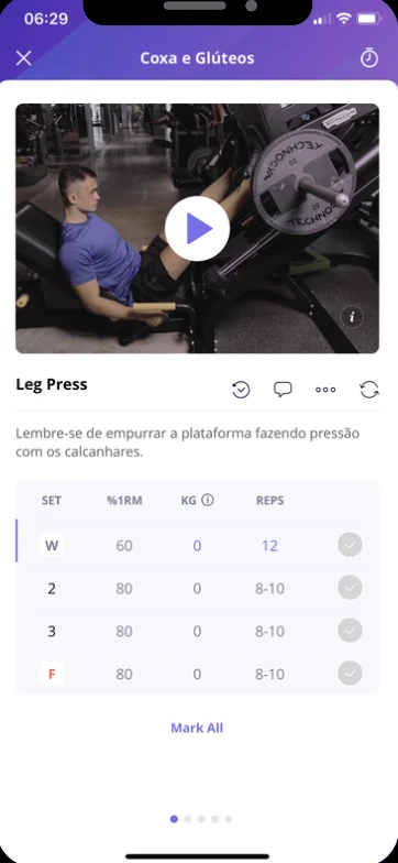 Tela do aplicativo com o exercício Leg Press: vídeo de execução, orientação técnica e tabela com séries, percentual de 1RM, carga e repetições